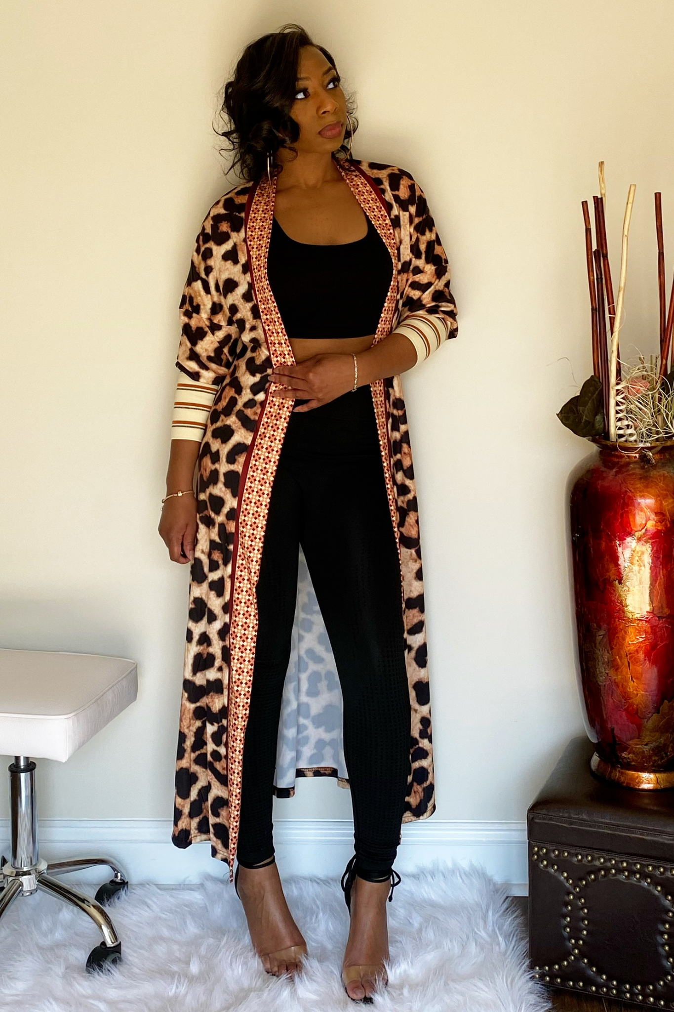 Full length animal print cardigan with three quarter sleeves paired with a black two piece set.. The end sleeves have nude color block with red and black stripe detailing.