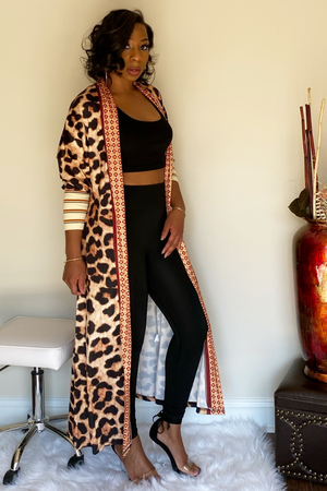 Full length animal print cardigan with three quarter sleeves paired with a black two piece set.. The end sleeves have nude color block with red and black stripe detailing.